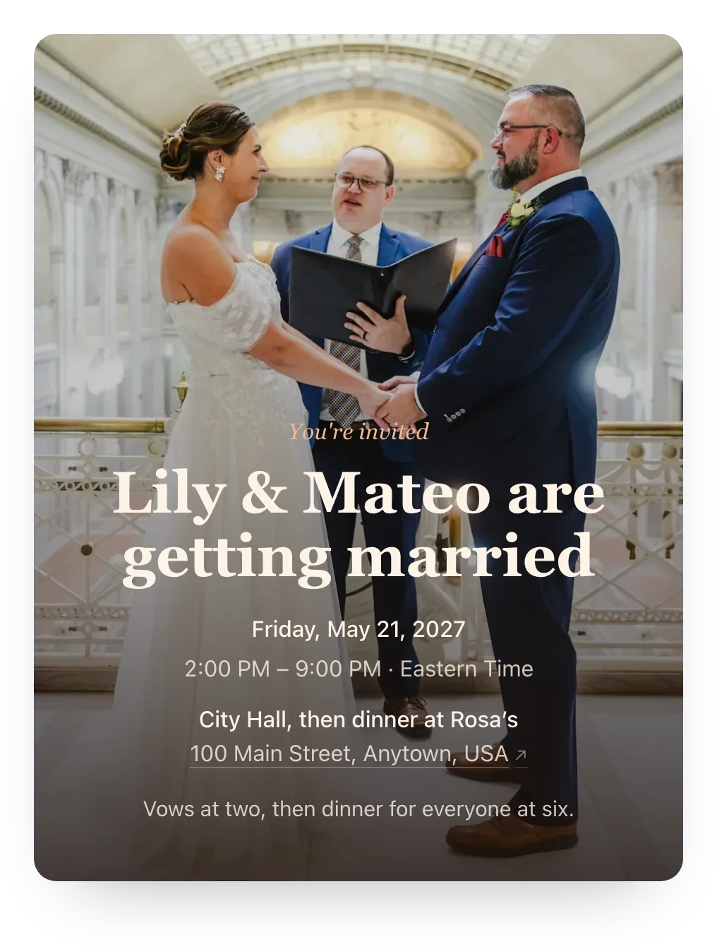Courthouse wedding invitation with the couple’s own photo as the cover: a bride and groom holding hands as an officiant reads their vows in a city hall atrium, behind “Lily & Mateo are getting married”