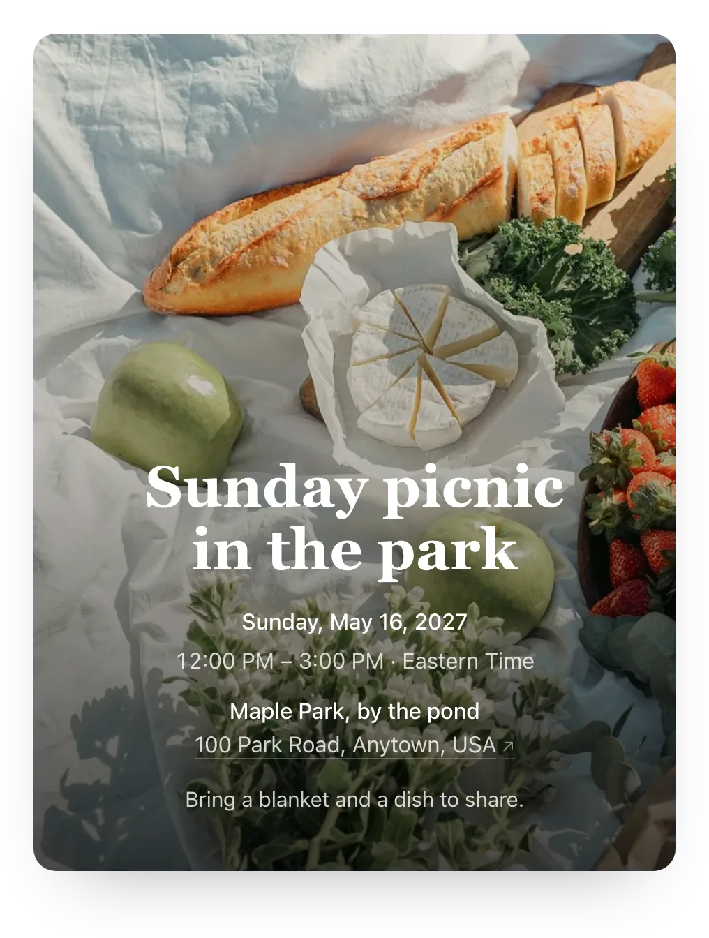 Picnic invitation with the host’s own photo as the cover: bread, cheese, and strawberries on a blanket behind “Sunday picnic in the park”