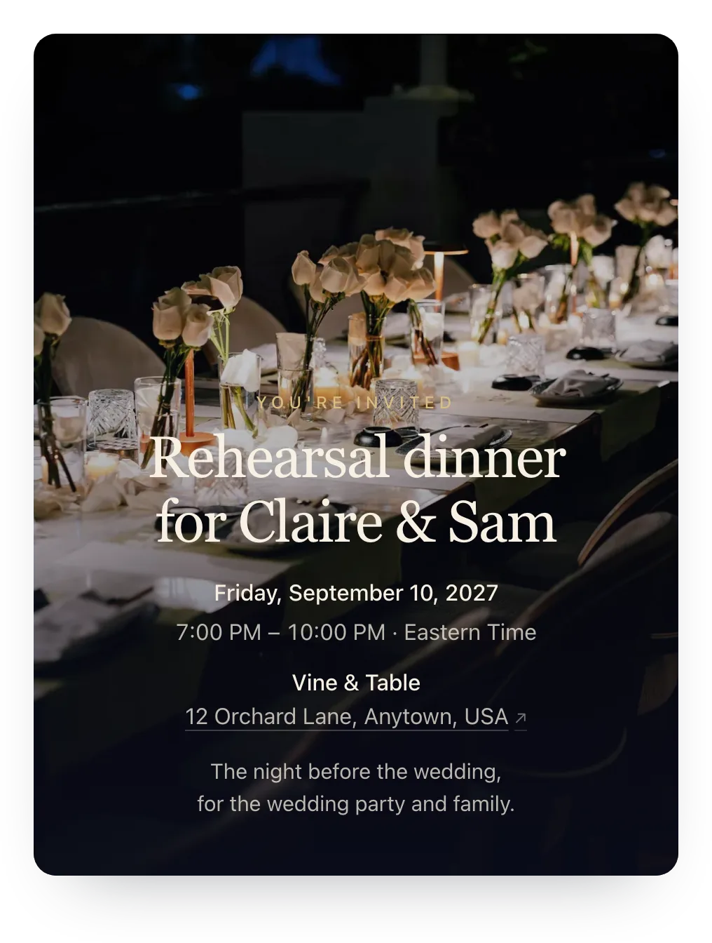 Rehearsal dinner invitation with the host’s own photo as the cover: a long candlelit dinner table set with white napkins, glasses, and slim vases of white flowers, behind “Rehearsal dinner for Claire & Sam”